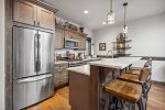 The kitchen features brand new stainless steel appliances